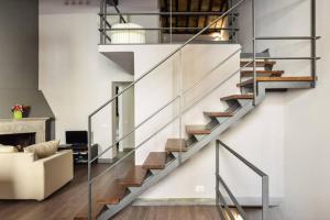 a staircase in a living room with a couch at Navona Rubens Lodge in Rome