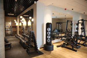 a gym with rows of treadmills and weights at Mazurski Raj - Hotel, Marina & Spa in Ruciane-Nida