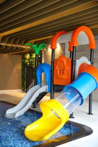 a childrens playground with a slide and a play equipment at Mazurski Raj - Hotel, Marina & Spa in Ruciane-Nida