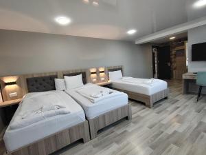 Vita Gardenia Hotel Tskaltubo में एक कमरे में एक या कई बेड