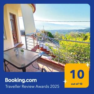 a balcony of a house with a table and a view at Up on the hill in Nafpaktos