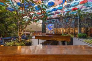 a restaurant with a table and a ceiling with umbrellas at Hyatt Centric Candolim Goa in Calangute