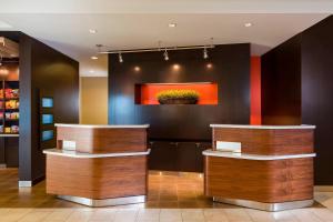 a lobby with two counters and a painting on the wall at Courtyard by Marriott Kalamazoo Portage in Portage