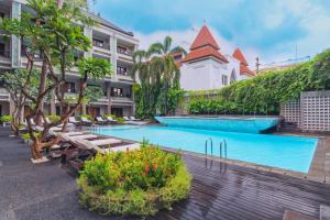 un complejo con piscina y un edificio en The Vira Bali Boutique Hotel & Suite, en Kuta