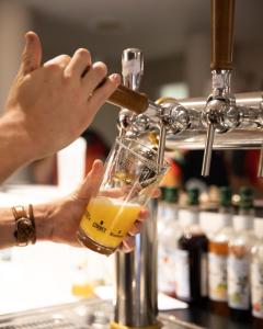 a person is pouring a drink into a glass at The People - Tours in Tours