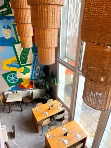 a restaurant with tables and chairs in a room at The People - Tours in Tours