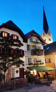 un grande edificio bianco con una torre dell'orologio sullo sfondo di I da Mitt a Hallstatt