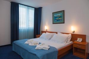 a hotel room with a bed with towels on it at Hotel Rotondo in Trogir