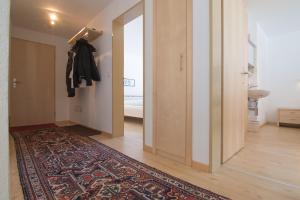 a hallway with a rug on the floor and a door at Mischi 5 in Saas-Fee