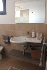 a bathroom with a sink and a mirror at Casa Giuliani in Porto Cesareo