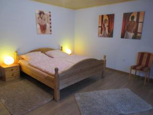 a bedroom with a bed and two lamps and a chair at Ferienhaus Schulze in Schierke