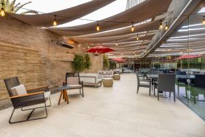 a restaurant with chairs and tables and umbrellas at Hilton Garden Inn Iquique in Iquique