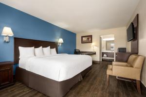 A bed or beds in a room at Baymont by Wyndham Kingman