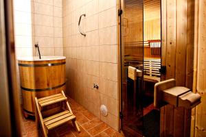 a bathroom with a sink and a chair in it at Villa Centrum Młodości in Augustów