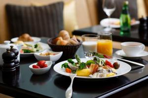 a table topped with plates of food and fruit at The Tokyo Station Hotel in Tokyo