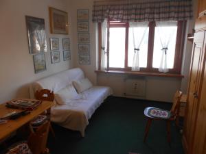 a living room with a couch and a table and a window at Monolocale Milky Way - Sestriere in Sestriere