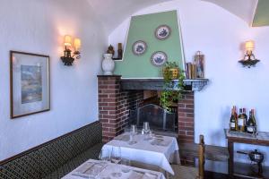 a dining room with two tables and a fireplace at Hotel Eden in Baveno