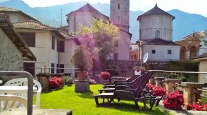 a group of chairs sitting in the grass in front of a building at Hotel Eden in Baveno