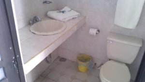 a bathroom with a white toilet and a sink at Hotel Real de Cuautla in Cuautla Morelos