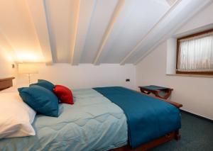 a bedroom with a bed with blue and red pillows at Villa Meri in Trogir