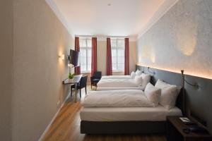 Cama ou camas em um quarto em Altstadt Hotel Krone Luzern