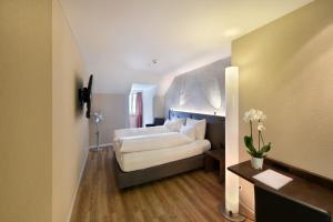 Cama ou camas em um quarto em Altstadt Hotel Krone Luzern