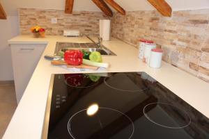 a kitchen with a stove with vegetables on a counter at Dubrovnik Rupe Apartment in Dubrovnik