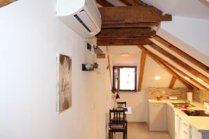 a kitchen with a ceiling with wooden beams at Dubrovnik Rupe Apartment in Dubrovnik