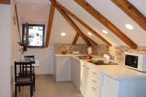 a kitchen with white cabinets and a counter top at Dubrovnik Rupe Apartment in Dubrovnik