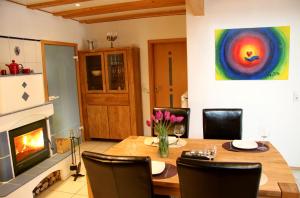 a dining room with a table and a fireplace at Haus Winkelchen in Cochem