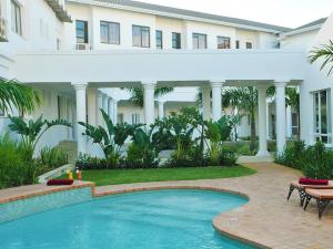 a swimming pool in front of a building at Premier Hotel The Richards in Richards Bay