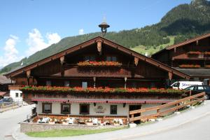 un edificio con flores a un lado. en Gasthaus Jakober, en Alpbach