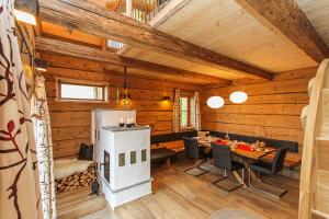 uma sala de jantar num chalé de madeira com uma mesa e cadeiras em Chalet Die Mühle em Saalfelden am Steinernen Meer