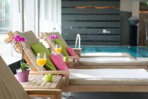 - une rangée de lits dans une piscine avec des verres de vin dans l'établissement Steigenberger Airport Hotel Amsterdam, à Schiphol