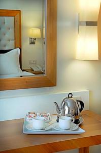 a tray with a tea kettle and two cups on a table at Tugcu Hotel Select in Bursa