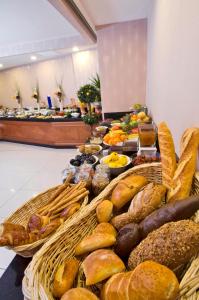 a buffet with baskets of bread and other foods at Tugcu Hotel Select in Bursa