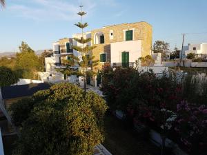 a view of a building with some bushes and flowers at Archipelagos in Naxos Chora