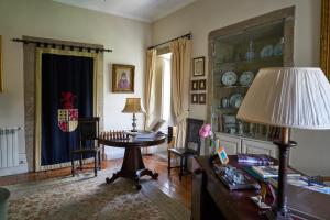 a living room with a table and a lamp at Casa De Fatauncos in Vouzela