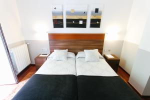 Una cama o camas en una habitación de Hostal San Ignacio Centro