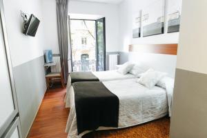 Una cama o camas en una habitación de Hostal San Ignacio Centro