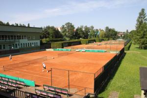 a group of people playing tennis on a tennis court at Penzion Tenis Klub DEZA in Valašské Meziříčí