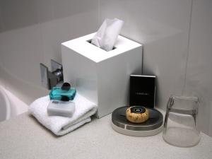 una barra de baño con una caja de pañuelos y un cupcake en Chaucer Palms Boutique B&B, en Newcastle