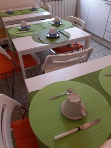 a dining room with green and white tables and chairs at B&B IL TABERNACOLO in Florence