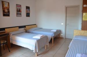 Cama ou camas em um quarto em Albergo Roma