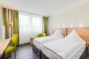 เตียงในห้องที่ Novina Hotel Wöhrdersee Nürnberg City