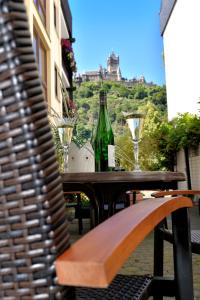 a wooden table with a bottle of wine on it at Apartments Haus Daniela in Cochem