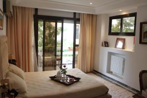 a room with a bed with a tray with flowers on it at Villa Sidi Bou Said in Sidi Bou Saïd