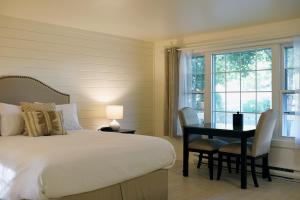 a bedroom with a bed and a table and chairs at Sandwich Inn and Suites in Sandwich