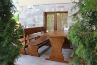 a wooden table and a bench in front of a building at Family Hotel Relaxa in Sapareva Banya