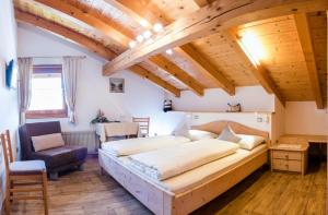 a bedroom with a large bed in a room with wooden ceilings at Apartment Suliva in Santa Cristina in Val Gardena